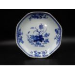 An 18th Century Chinese octagonal blue and white shallow Bowl painted flowering shrubs, 10in diam.