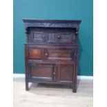 An 18th Century oak Deudarn dated 1713 to the carved frieze above a pair of small cupboard doors,