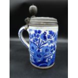A large antique Delft blue and white Tankard, painted bird amongst flowering shrubs, pewter lid with