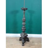 An 18th Century Eastern brass Pricket Candlestick, the upper drip pan mounted with winged figures
