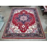 A Persian Carpet with multiple borders, stylised floral designs with a central blue star medallion