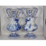 An impressive pair of 19th Century Dutch Delft two handled Vases with narrow cannon barrel necks