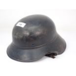 A WWII German Helmet with partial printed badge