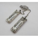 An early 20th Century silver Chatelaine with two suspended pockets, one containing notebook