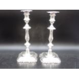 A pair of Edward VII silver Candlesticks with knopped stems on shaped square bases, Sheffield