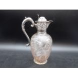 An Edward VII silver mounted and lidded glass Claret Jug with floral and gadroon embossing,