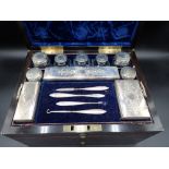 A Victorian Coromandel Dressing Case containing silver lidded boxes and jars with finely engraved