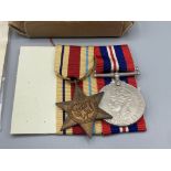 Three; WWII trio including War Medal, 1939-45 Star and Africa Star, with box of issue and condolence