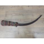 An African antelope horn and carved Ceremonial Horn with beadwork decoration 2ft 9in L