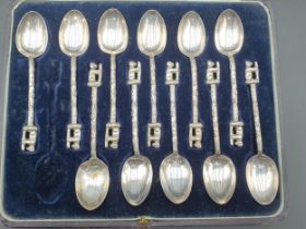 A Cased Set of eleven Edward VII silver Coffee Spoons with trunk handles and bear finials,