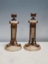 A pair of alabaster and gilt metal Table Lamps with scrolled leafage supports and circular bases,