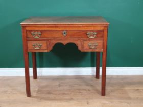 A Georgian mahogany Lowboy fitted three drawers around a shaped frieze on chamfered squared