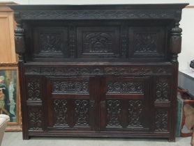 A large oak Court Cupboard in the 17th Century style with tulip and grape carved doors 8ft 2in W