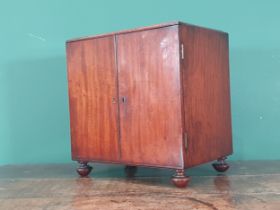 A 19th Century mahogany Sewing Cabinet fitted a pair of cupboard doors enclosing a top drawer with