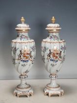 A pair of Chinese armorial Vases and Covers of spiral moulding and decorated sprays of flowers on