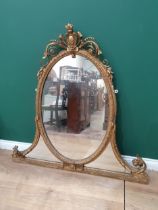 A 19th Century gilt Overmantel Mirror with pierced and scrolled surmount above the oval plate