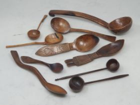 A collection of treen Spoons including two Toddy Ladles, two Ladles, a carved and dated Love