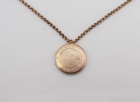 A circular 9ct gold Locket with engine turning and monogram engraved to reverse on chain marked