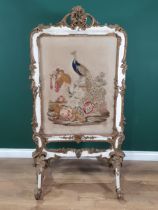 A 19th Century gilt and white painted Firescreen with floral and scrolled surmount above a