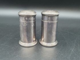 A pair of silver straight sided Pepperettes with gadroon rims, London 1930 & 1937, 150gms