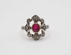 A Ruby and Diamond Cluster Ring rubover-set oval-cut ruby within openwork frame set brilliant-cut