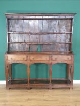 An 18th Century oak Cardiganshire Dresser and Rack, the rack with two shelves having blacksmith