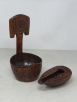 A carved treen Feeding Cup with shaped spout with carved tulip designs and the word 'RIGI', the