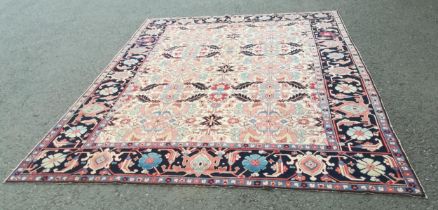 A large modern Carpet with leafage design on cream ground within blue border 13ft 1in L x 10ft 4in W