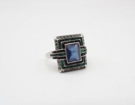 An Art Deco Cocktail Ring millegrain-set blue, green and white paste to the rectangular plaque, in