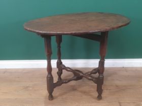 A late 17th Century Coaching Table with elm oval top raised upon oak baluster and squared supports