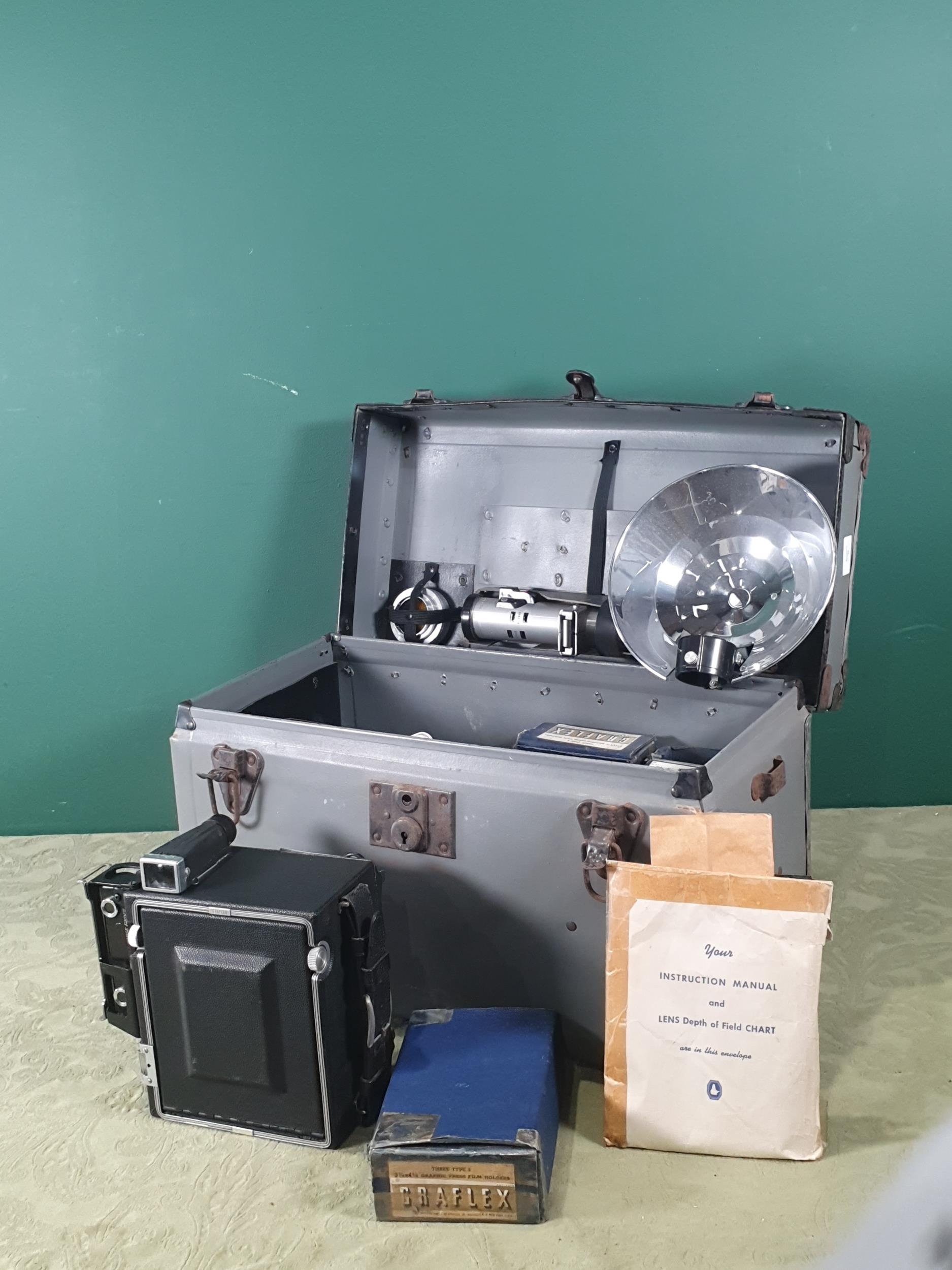 A Graflex Speed Graphic large format folding bellows Camera Outfit including film backs, flash and