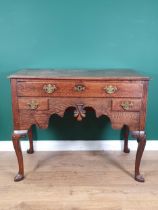 An 18th Century oak Lowboy with moulded top above three drawers on a shaped frieze, raised on