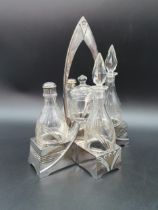 An Arts & Crafts five bottle Cruet on plated stand with central handle, 9 1/2in, marked BM, 1/10