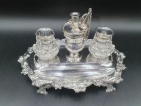 A William IV silver shaped oval Inkstand with floral and scroll border, fitted inkwell, sander and