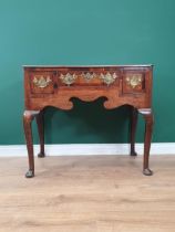 An 18th Century oak Lowboy fitted three crossbanded drawers above a shaped frieze and raised on four