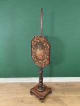 A Regency mahogany Pole Screen, the octagonal adjustable woolwork screen above a shaped base on