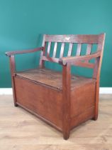 An antique oak Box Settle with slat back rest on square supports, 2ft 9"High x 3ft 1"Wide