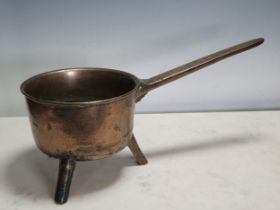An antique bell metal Skillet, the handle inscribed 'Warner' on three peg supports, 16in,