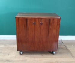 A Silkborg Danish rosewood Cocktail Cabinet fitted pair of cupboard doors raised on plastic