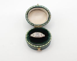 An Art Deco Diamond Ring pavé-set brilliant-cut stones between trios of eight-cut stones, stamped