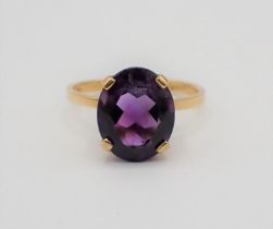 An Amethyst Dress Ring claw-set oval-cut stone, stamped 750, ring size N