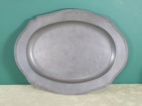 A large rococo pewter Serving Dish of shaped oval form, reeded edge and engraved Coat of Arms, 22½in