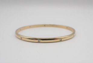 A Diamond Bangle gypsy-set eleven brilliant-cut stones in gold, unmarked, untested, approx 20gms