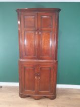 A George III oak Double Corner Cupboard with panelled doors enclosing shaped shelves, 6ft 6in H