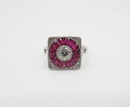 An Art Deco style Diamond and Ruby Target Ring millegrain-set old-cut diamond within a round frame