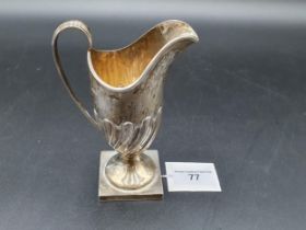 An Edward VII silver helmet shape Cream Jug with gadroon embossing on square base, Birmingham 1903