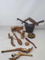 A collection of treen items including a 19th Century turned lead weighted Fishing Priest, a goose