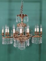 A brass four branch, twelve sconce Electrolier with prismatic glass drops, 2ft 2in H