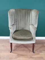A Regency barrel back Easy Chair with pale green upholstery on turned mahogany front legs and