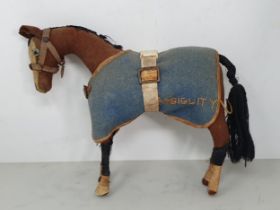 An antique felt covered Model of a Horse with blue rug named 'Ambiguity' 9 1/2in L